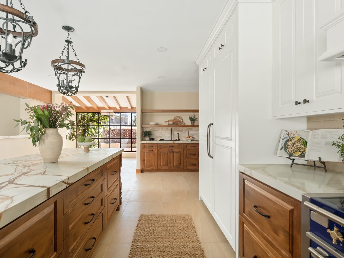 Spanish Modern kitchen with blue-gold quartzite island, maple cabinetry, and cream uppers, Reveal Interior Design Las Vegas
