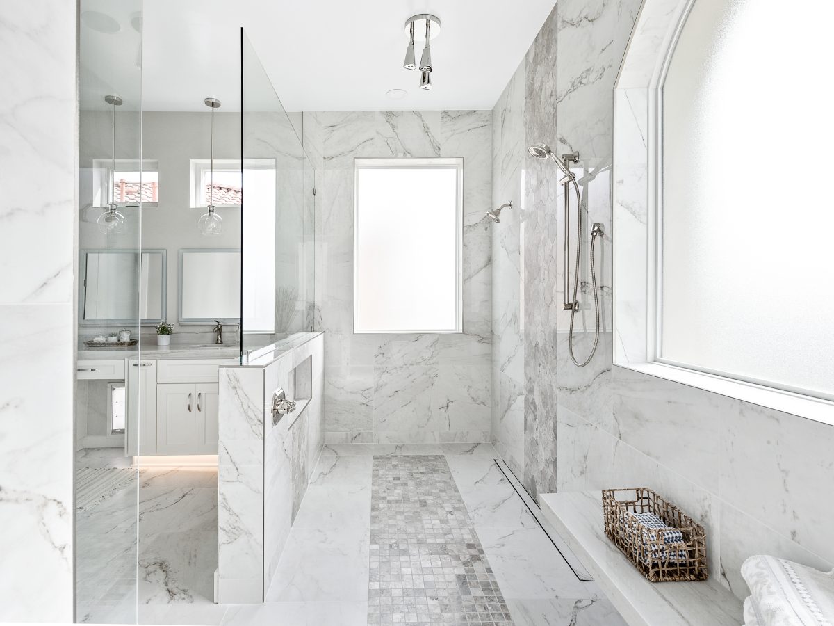 Transitional primary bathroom wet room with Taj Mahal quartzite and marble-look porcelain tile, Reveal Interior Design Las Vegas
