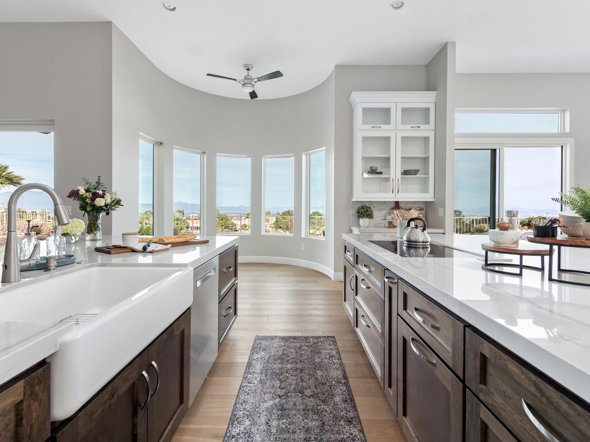Transitional kitchen with Taj Mahal quartzite countertops and dark stained maple cabinetry, Reveal Interior Design Las Vegas