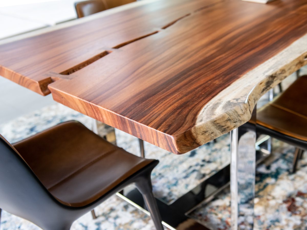 Custom live-edge dining table with polished steel legs and leather seating, Reveal Interior Design Las Vegas
