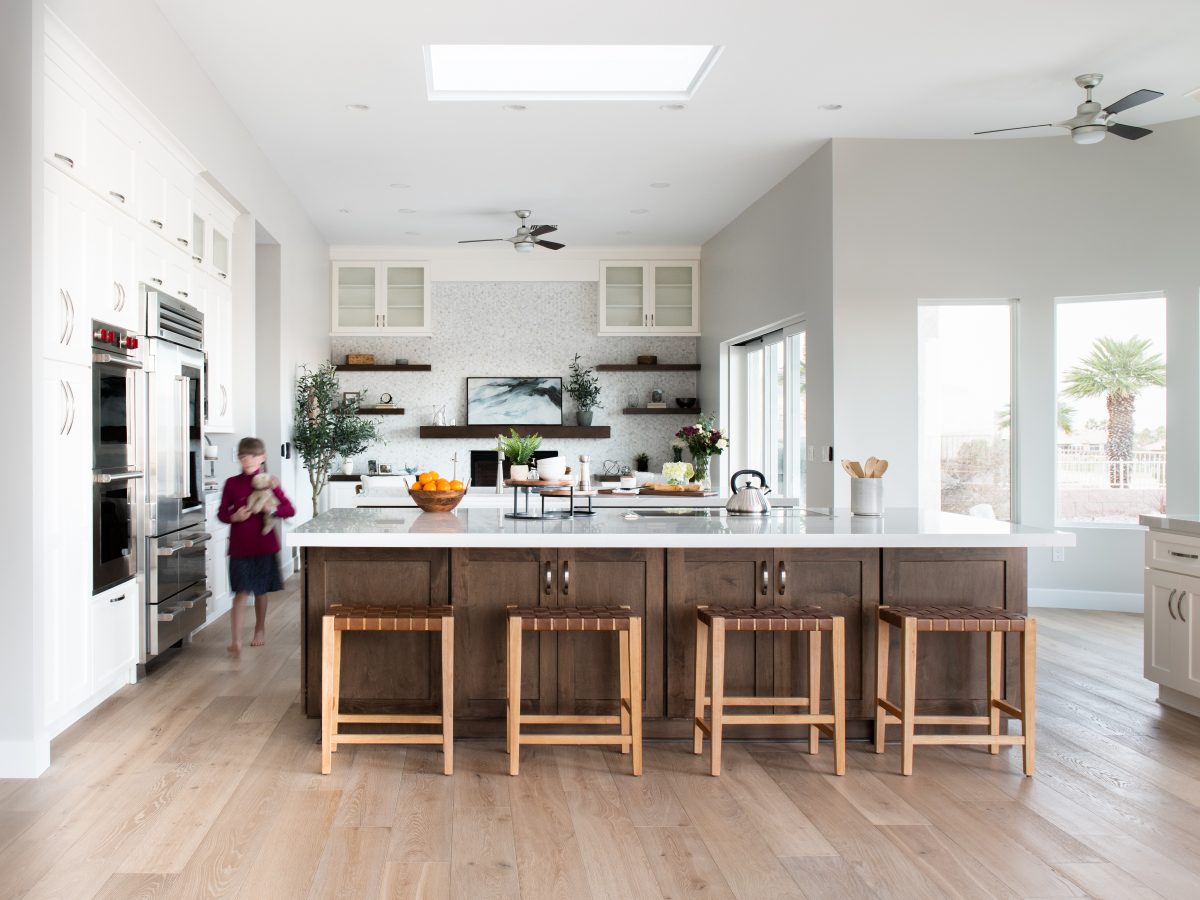 Transitional kitchen with Taj Mahal quartzite island, dark stained maple and off-white cabinetry, Reveal Interior Design Las Vegas