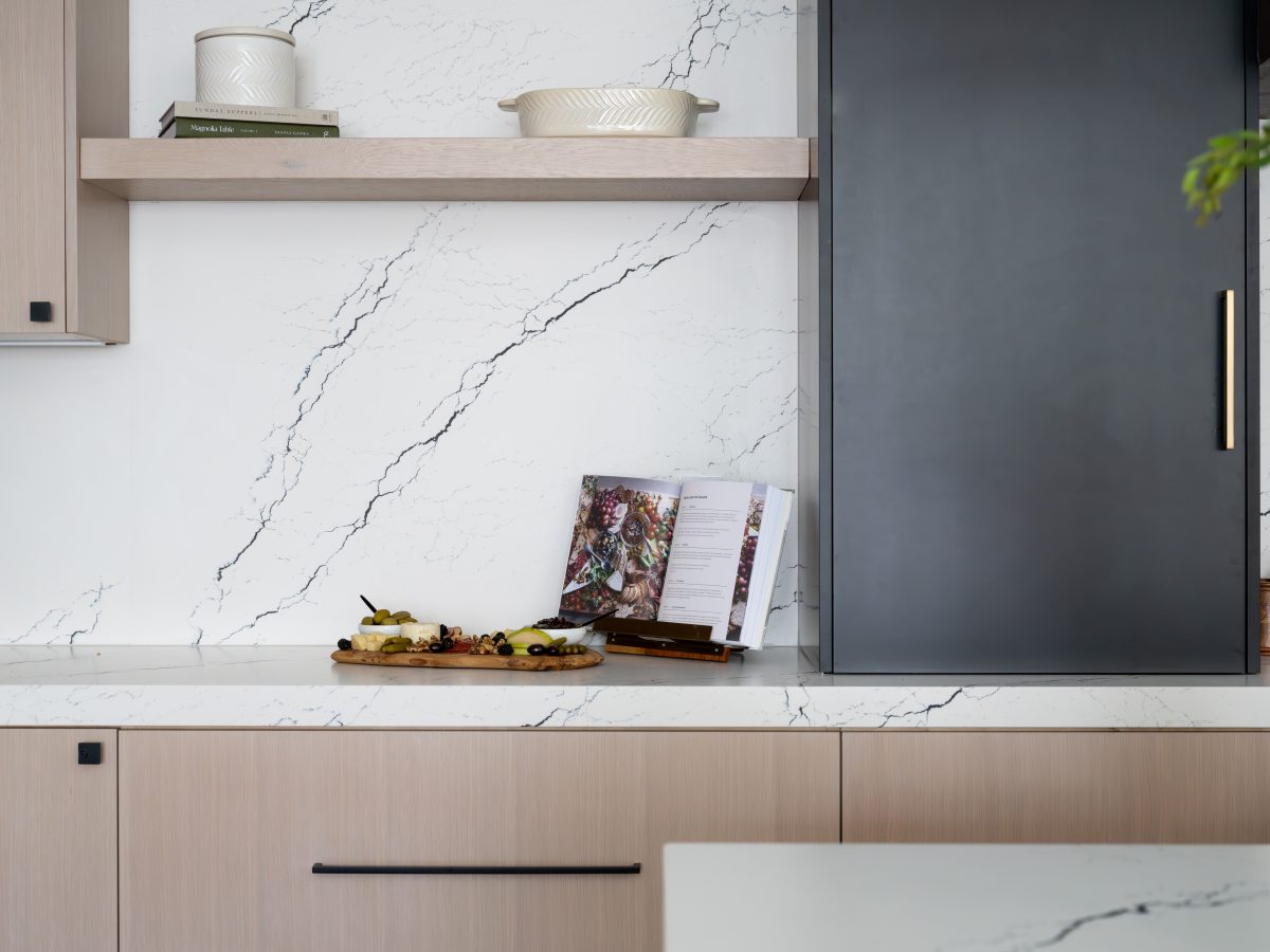 Kitchen with black-veined white quartz countertops and whitewashed oak cabinetry, Reveal Interior Design Las Vegas