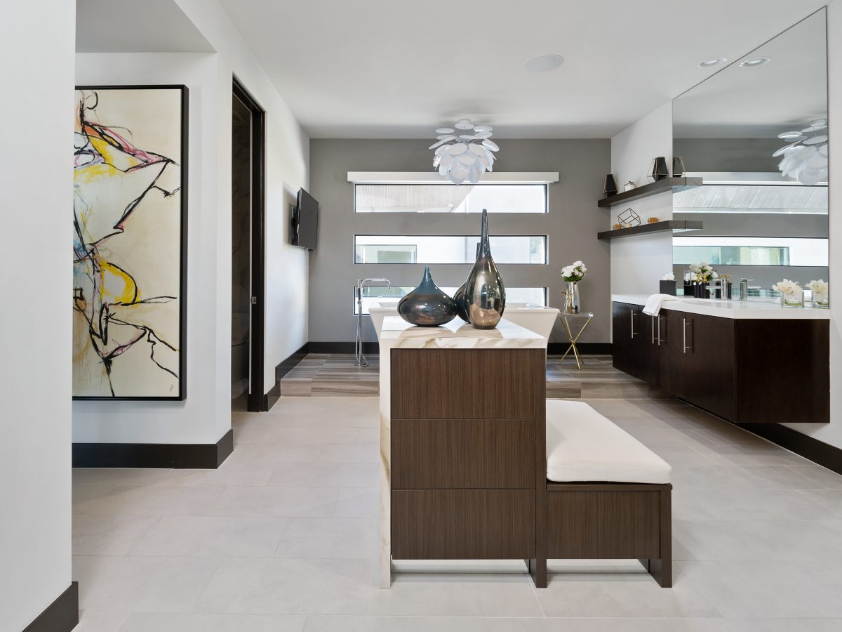 Primary bathroom with custom floating island, dark stained vanities, and quartz countertops, Reveal Interior Design Las Vegas