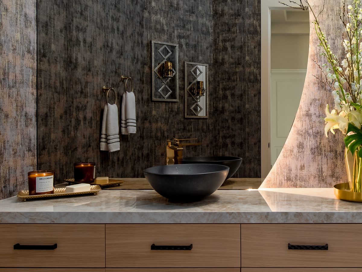 Powder room with backlit moon mirror, floating white oak vanity, and Taj Mahal Dekton countertop, Reveal Interior Design Las Vegas