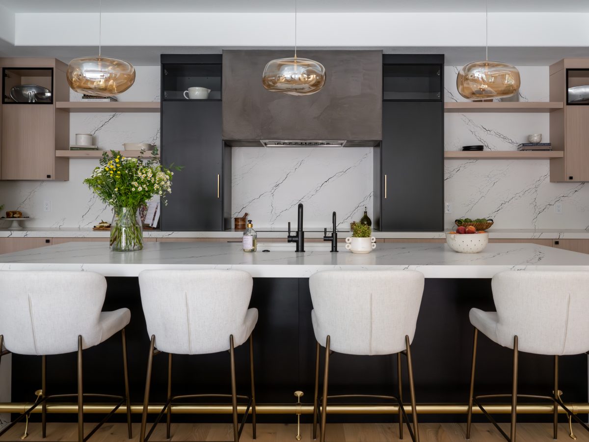 Contemporary kitchen with white quartz island, whitewashed oak cabinetry, and matte black accents, Reveal Interior Design Las Vegas