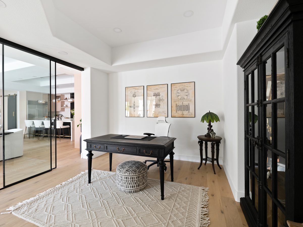 Home office with black steel-framed glass wall and oak engineered flooring, Reveal Interior Design Las Vegas