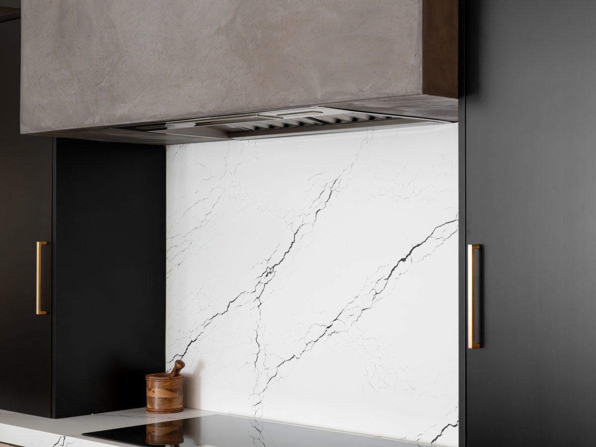 Modern kitchen with warm white-washed oak cabinetry, matte black accents, and black-veined white quartz, Reveal Interior Design Las Vegas
