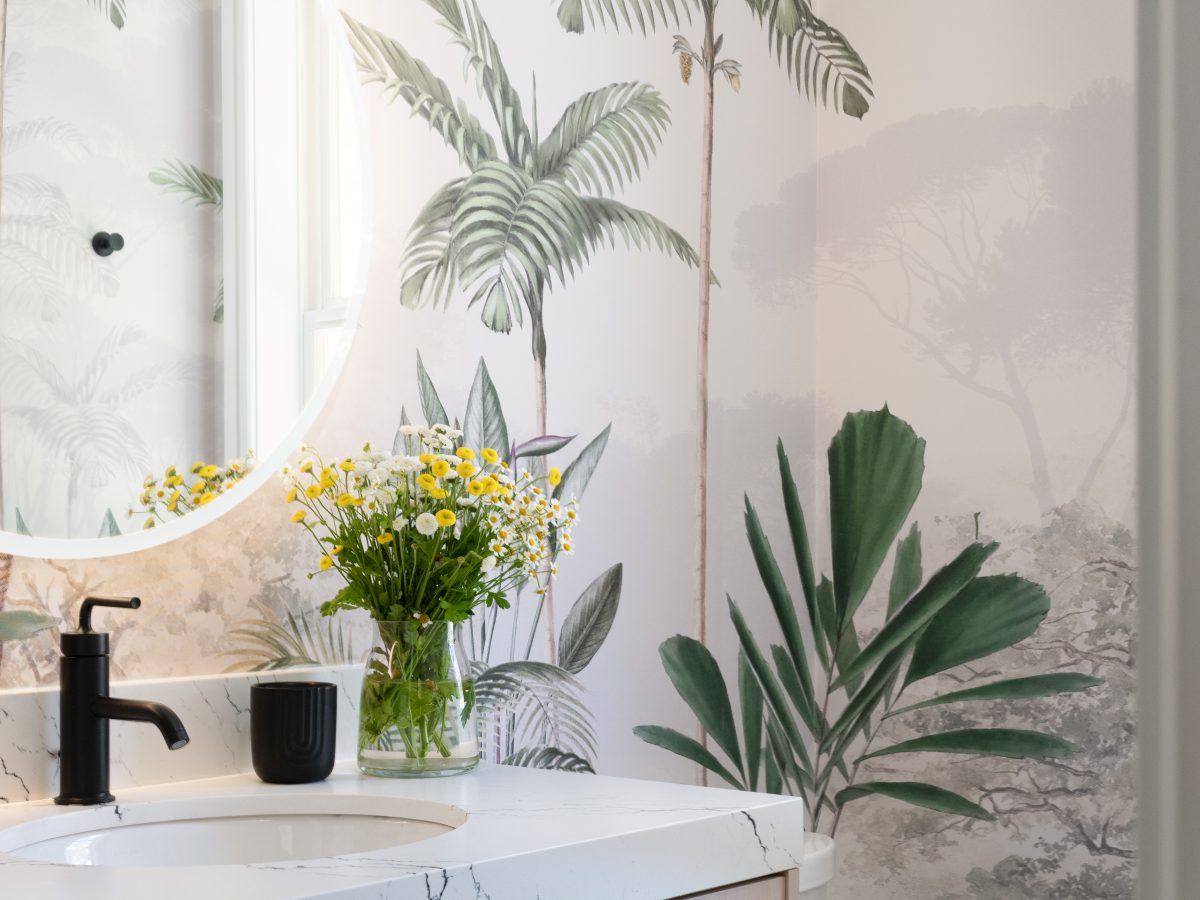 Powder bath with tropical botanical mural wallcovering and light wood vanity, Reveal Interior Design Las Vegas