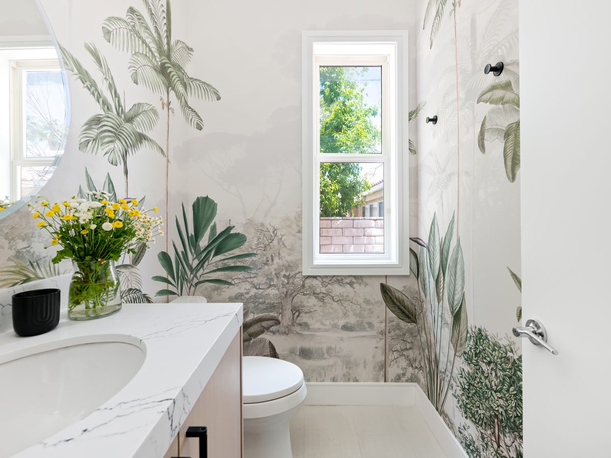 Powder bath with botanical mural wallcovering and stone countertops, Reveal Interior Design Las Vegas