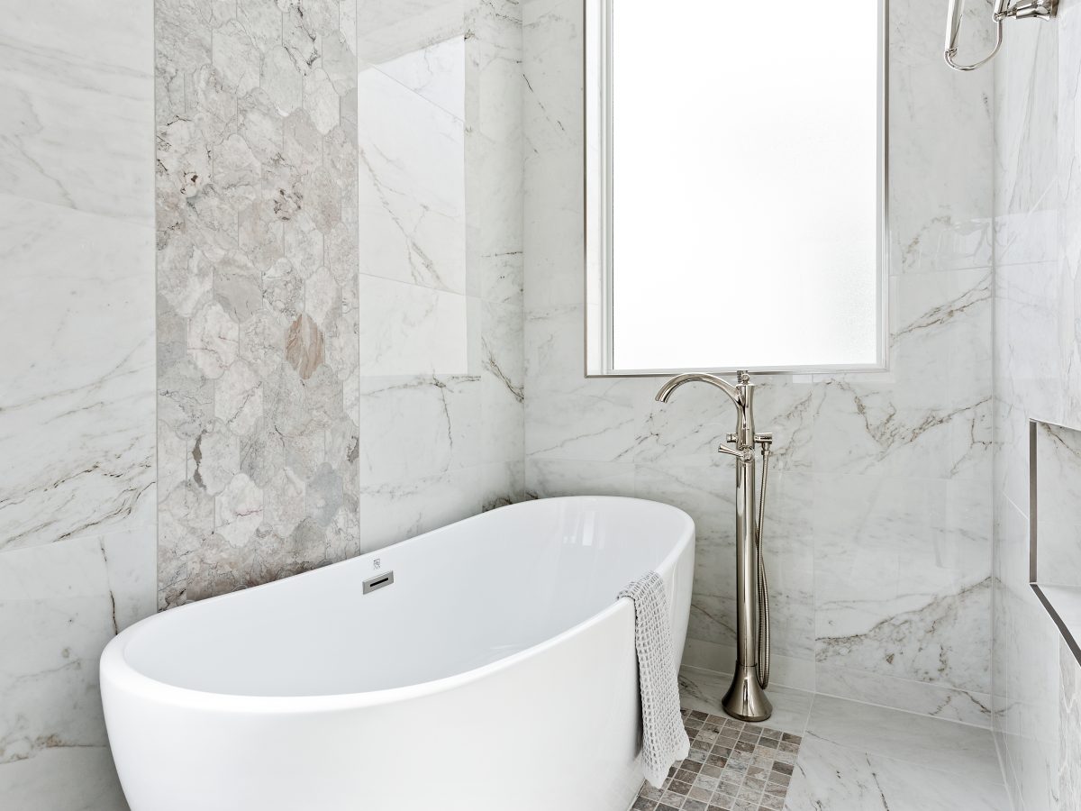 Transitional primary bathroom wet room with freestanding soaking tub and polished nickel floor-mount faucet, Reveal Interior Design Las Vegas