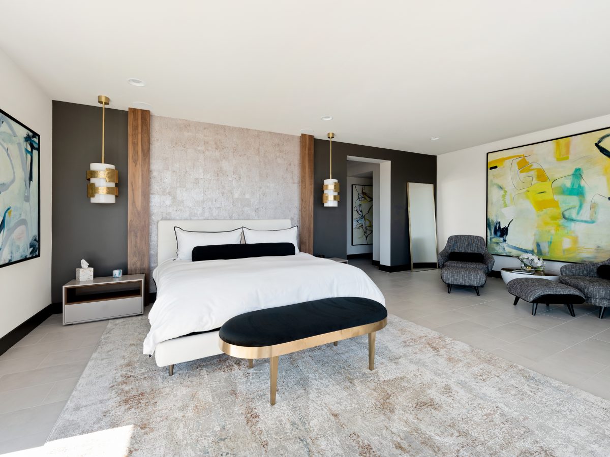 Primary bedroom with floor-to-ceiling walnut panels, Urbane Bronze accent wall, and custom local artwork, Reveal Interior Design Las Vegas