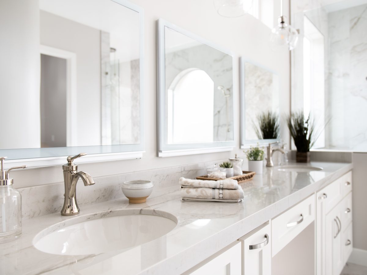 Transitional primary bathroom with Taj Mahal quartzite double vanity and polished nickel fixtures, Reveal Interior Design Las Vegas