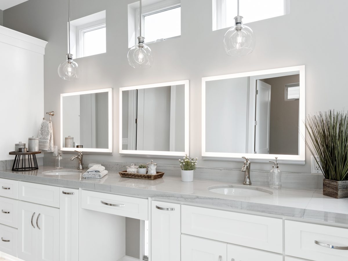Transitional primary bathroom with Taj Mahal quartzite double vanity and LED medicine cabinets, Reveal Interior Design Las Vegas