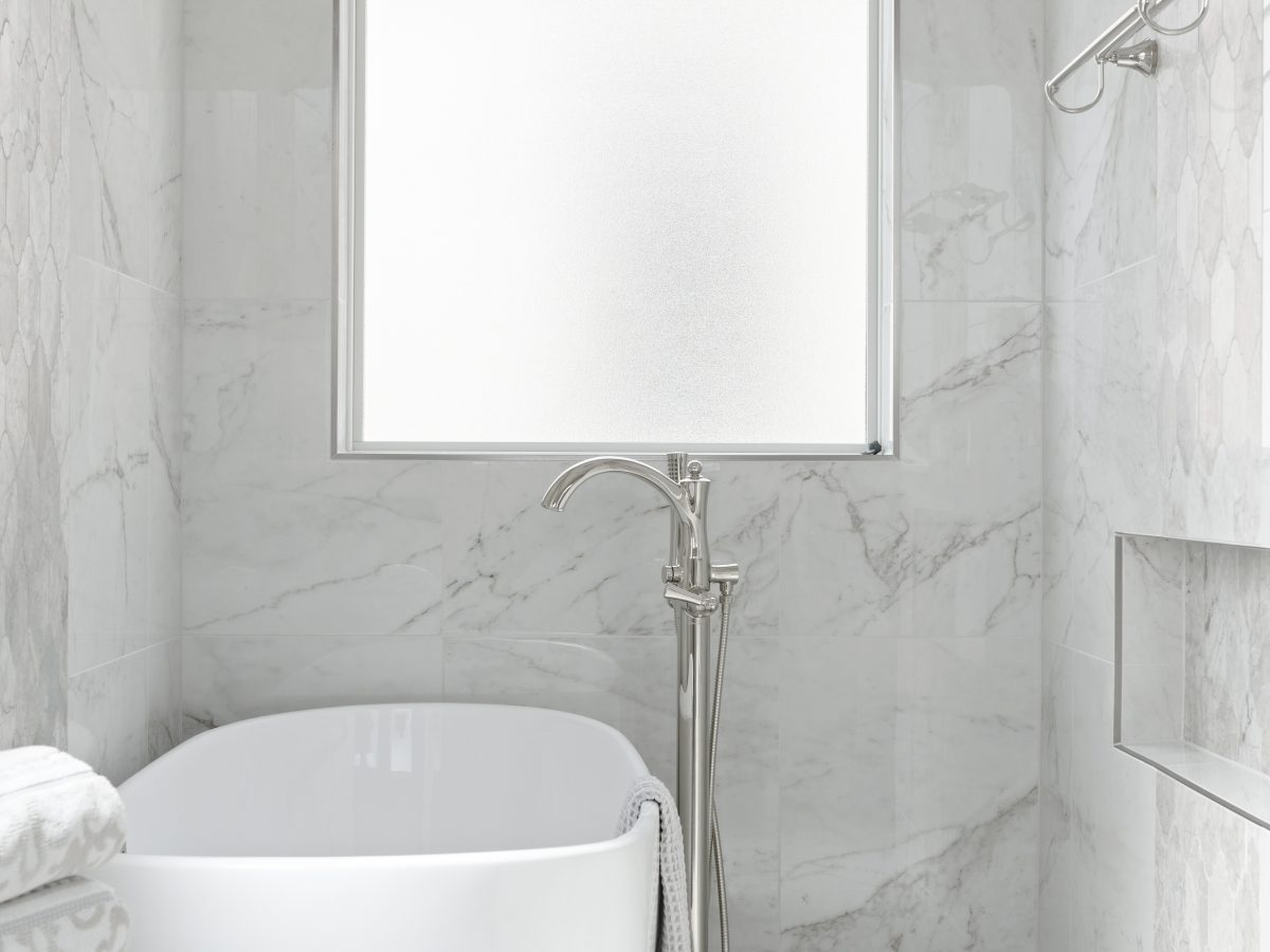 Transitional primary bathroom wet room with freestanding soaking tub and marble-look porcelain tile, Reveal Interior Design Las Vegas