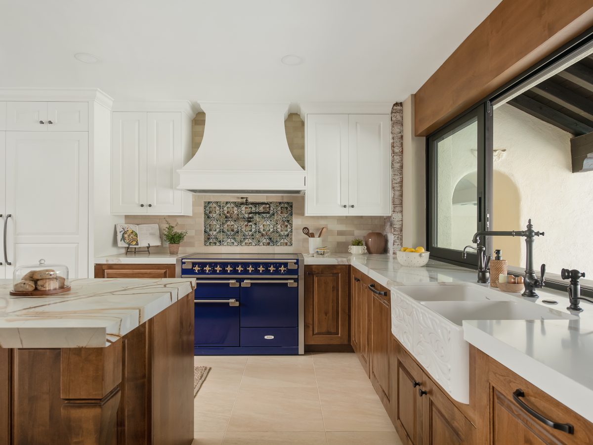 Spanish Modern kitchen with blue-and-gold quartzite island, stained maple cabinetry, and cobalt dual-fuel range, Reveal Interior Design Las Vegas