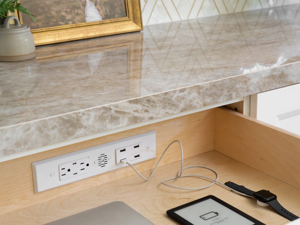 Kitchen charging drawer with Dekton countertop and geometric gold backsplash tile, Reveal Interior Design Las Vegas