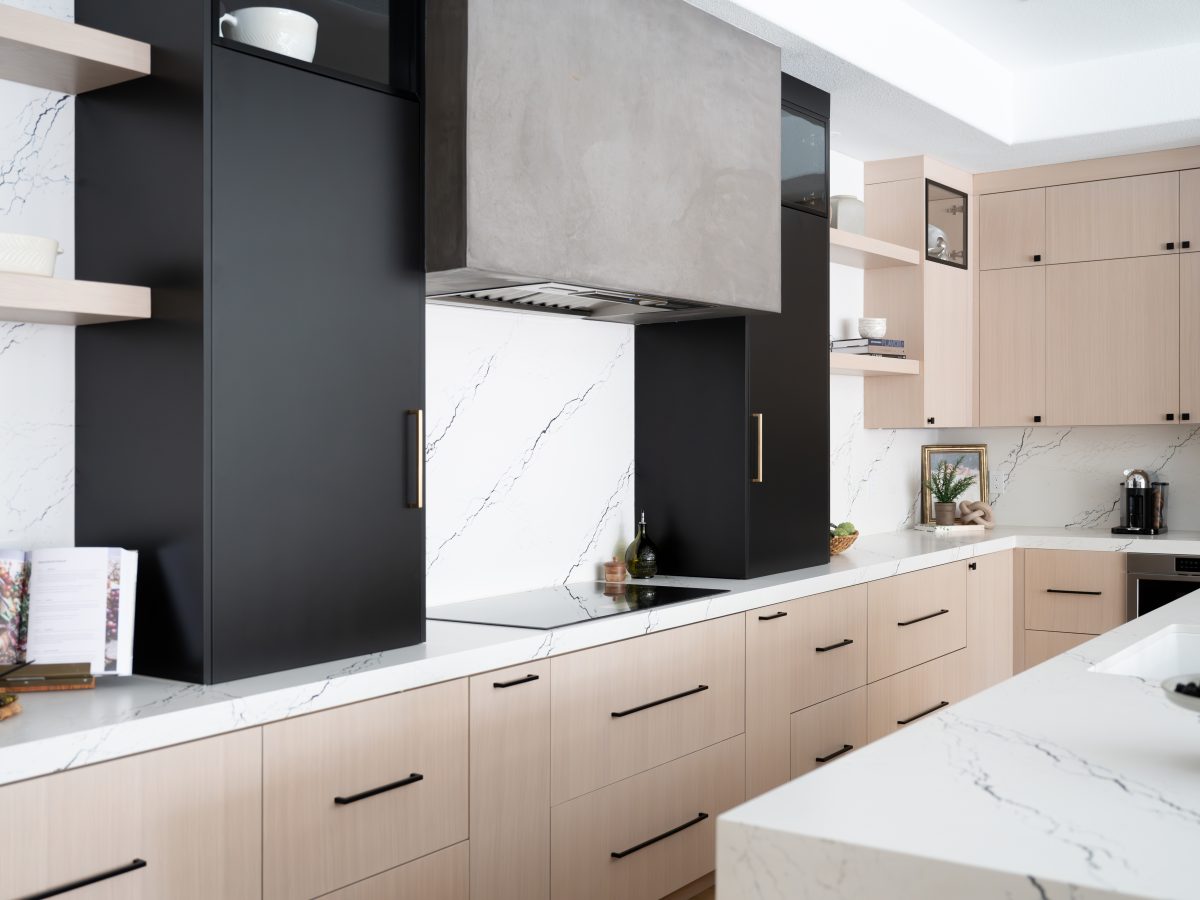 Modern kitchen with whitewashed oak cabinetry, matte black accents, and black-veined white quartz countertops, Reveal Interior Design Las Vegas