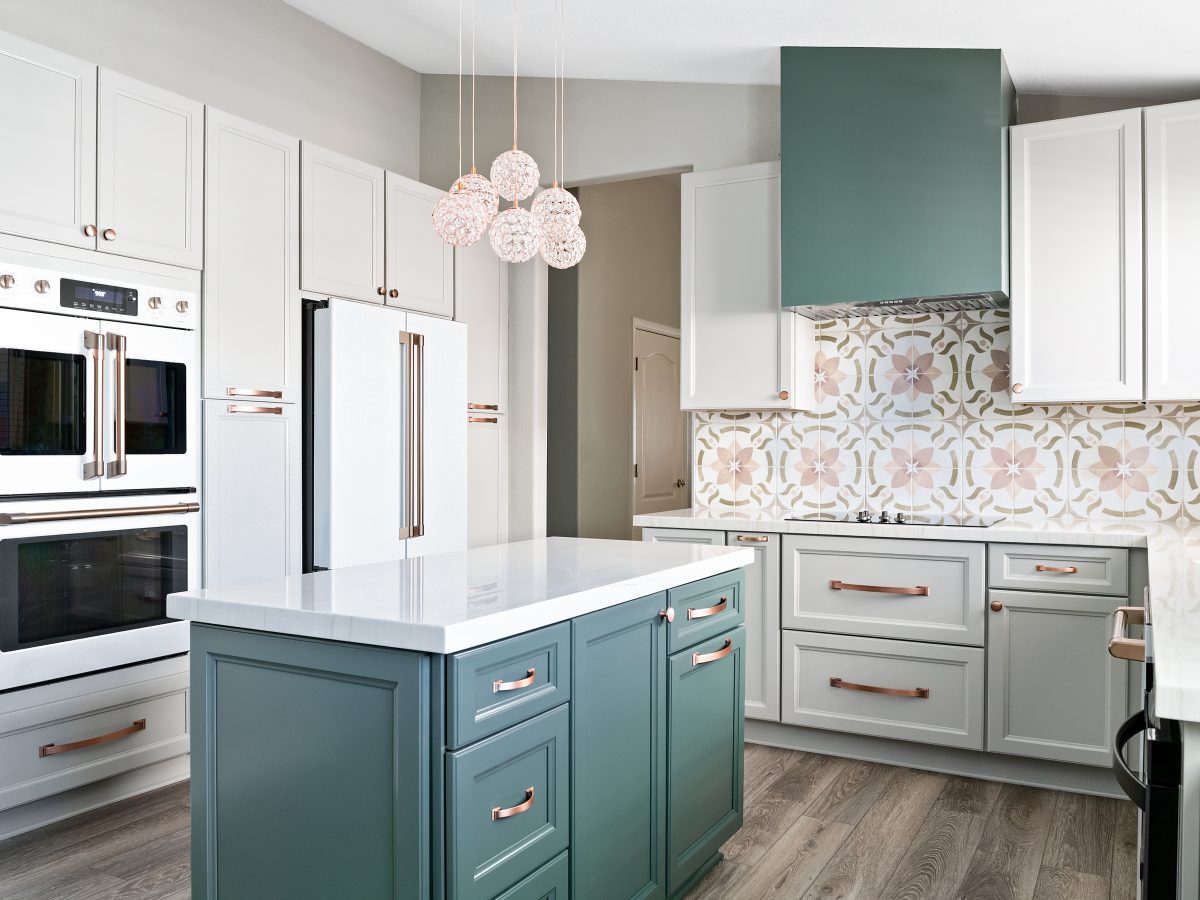 Transitional kitchen with emerald green island, encaustic ceramic tile backsplash, and copper hardware, Reveal Interior Design Las Vegas