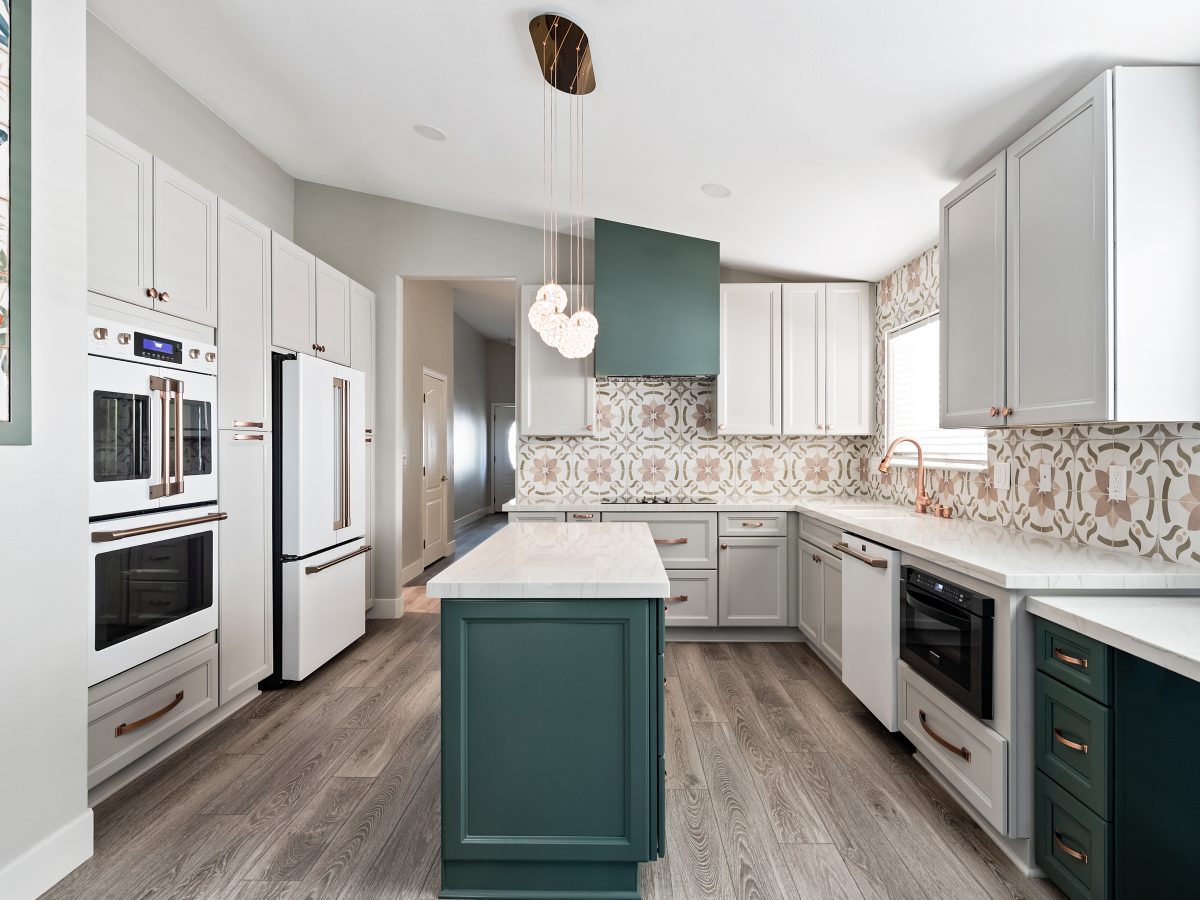 Emerald green and beige kitchen with encaustic ceramic tile backsplash, copper hardware, and white quartz island, Reveal Interior Design Las Vegas