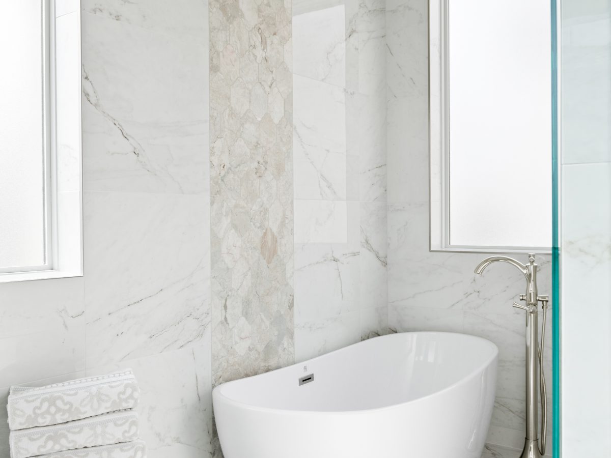 Transitional primary bathroom wet room with freestanding soaking tub and Taj Mahal quartzite accent, Reveal Interior Design Las Vegas