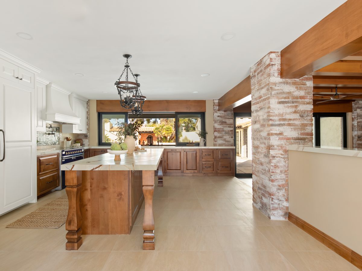 Spanish Modern kitchen with blue and gold quartzite island, whitewashed brick, and stained maple cabinetry, Reveal Interior Design Las Vegas